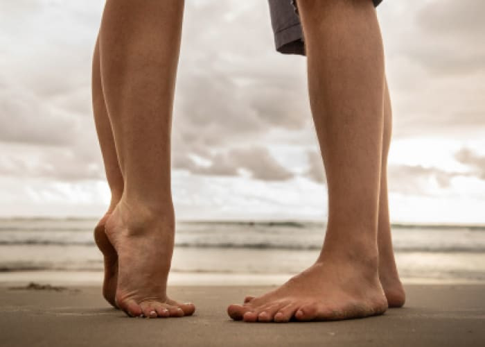 low section of lovers at beach