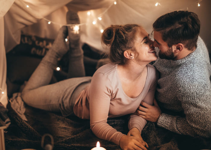 couple on bed together in romantic mood