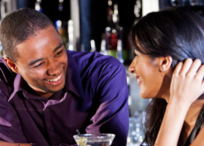 couple flirting at bar