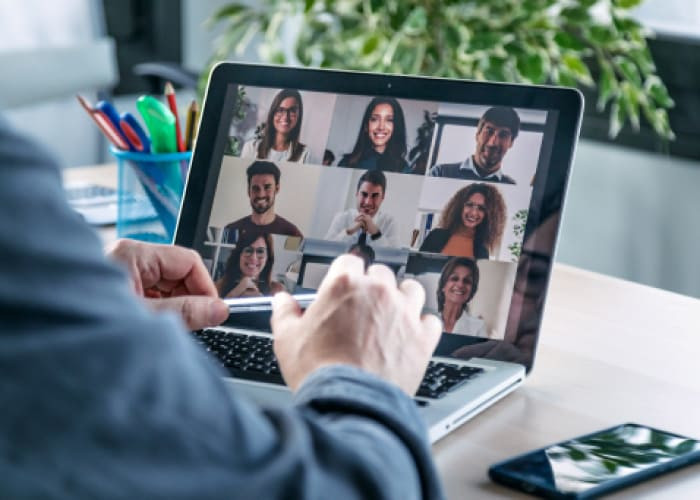 man speaking online with laptop