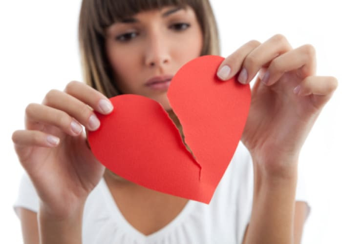 girl breaking a paper heart