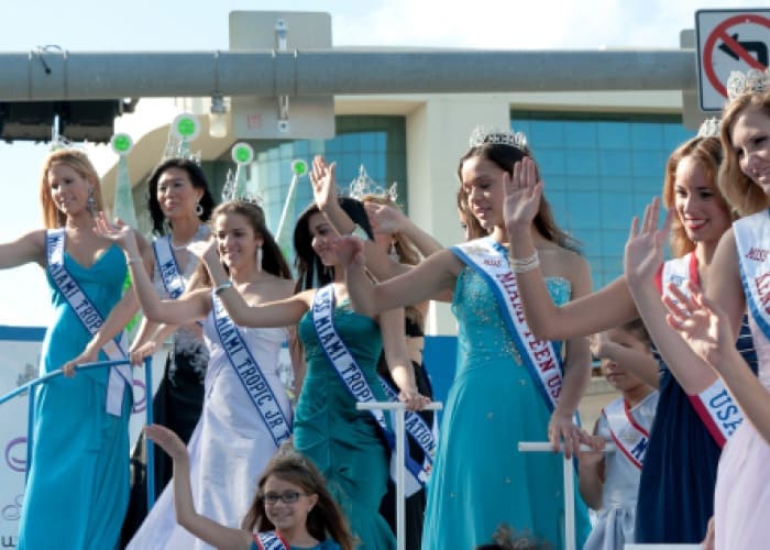 women pose at a parade