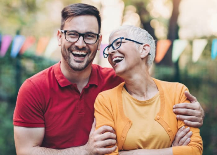 young man and older woman laughing together