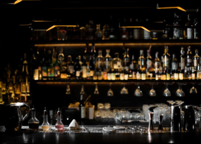 blurred background of dark bar with barman essentials	