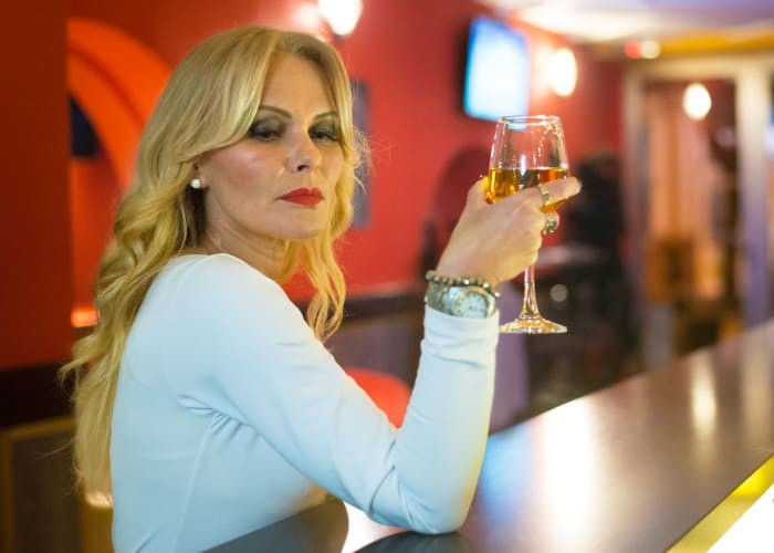 sexy woman in white dress sitting in the bar