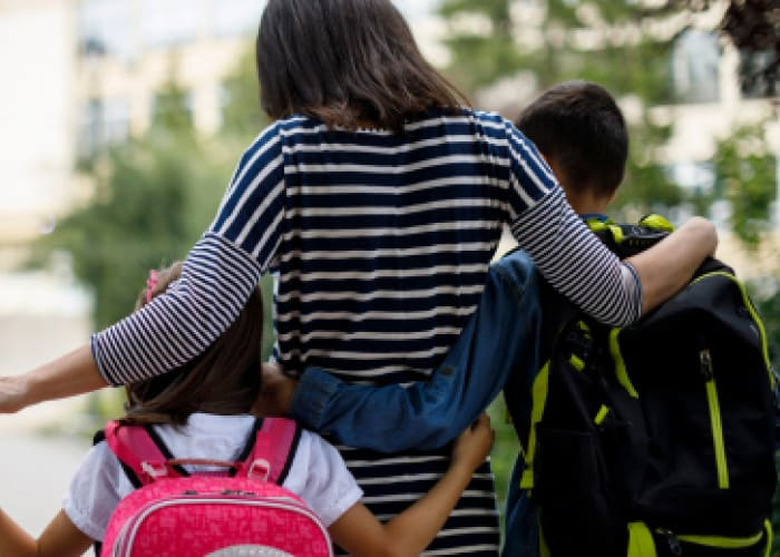 mother taking kids to school