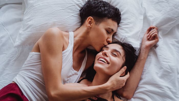 multiethnic same sex couple cuddling
