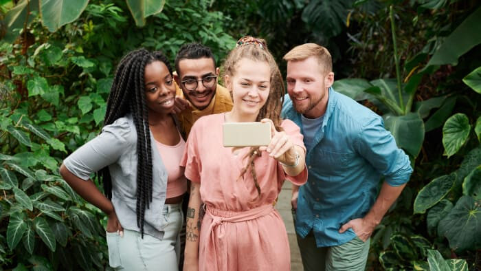 photo of four singles taking selfie