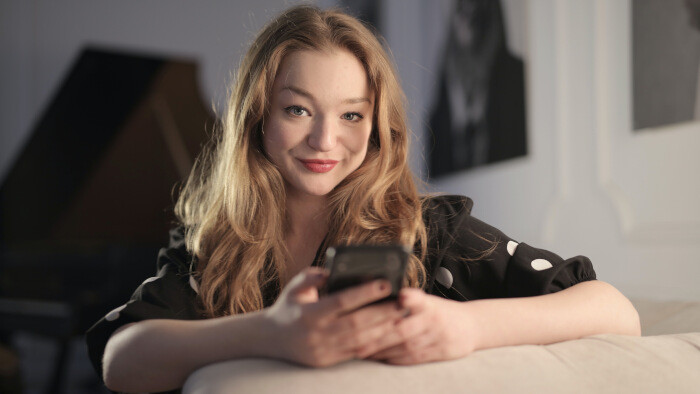 charming woman messaging horny texts on smartphone