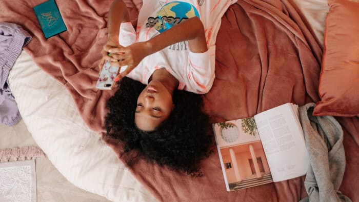 woman in white shirt lying on bed